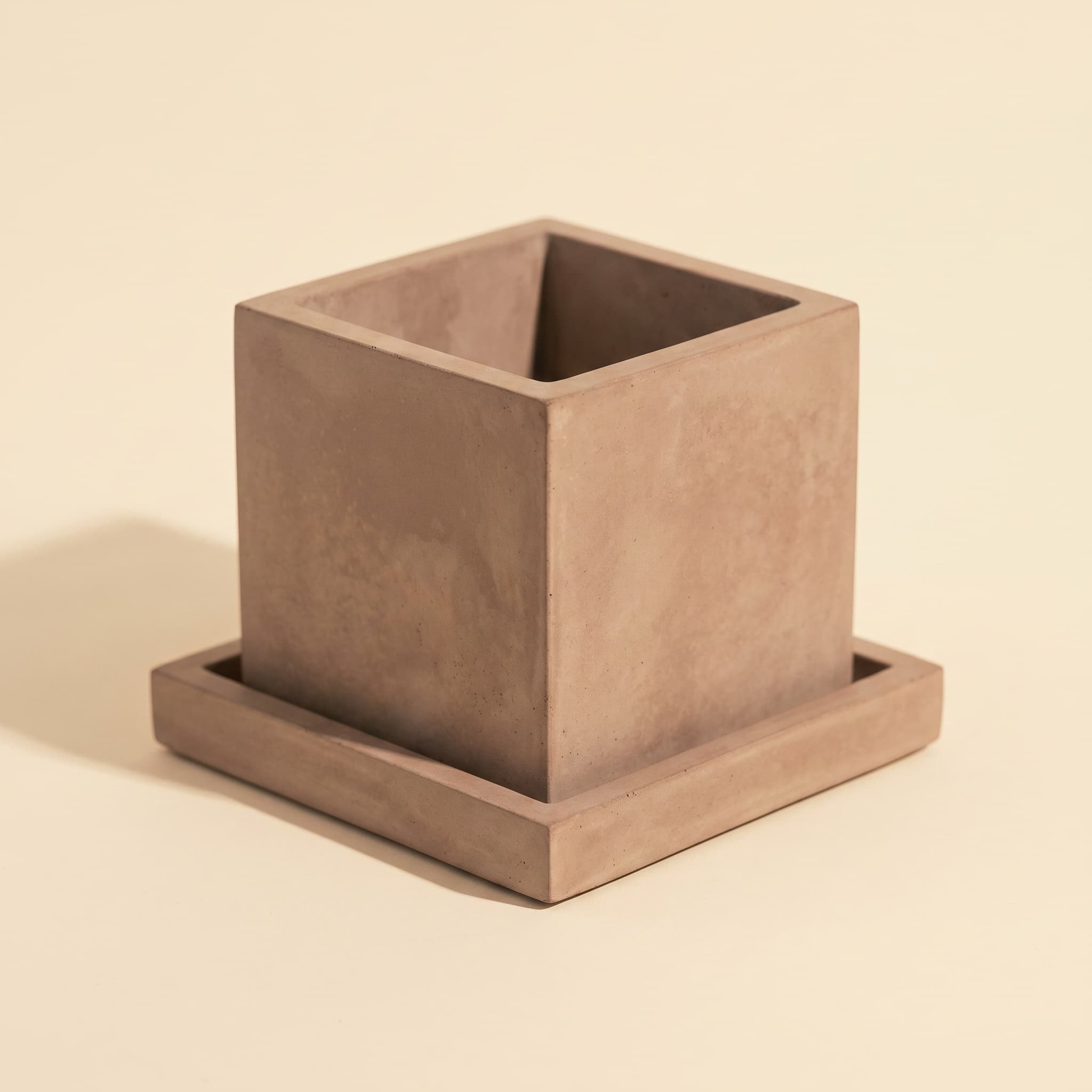 Taupe cube vessel on matching square saucer