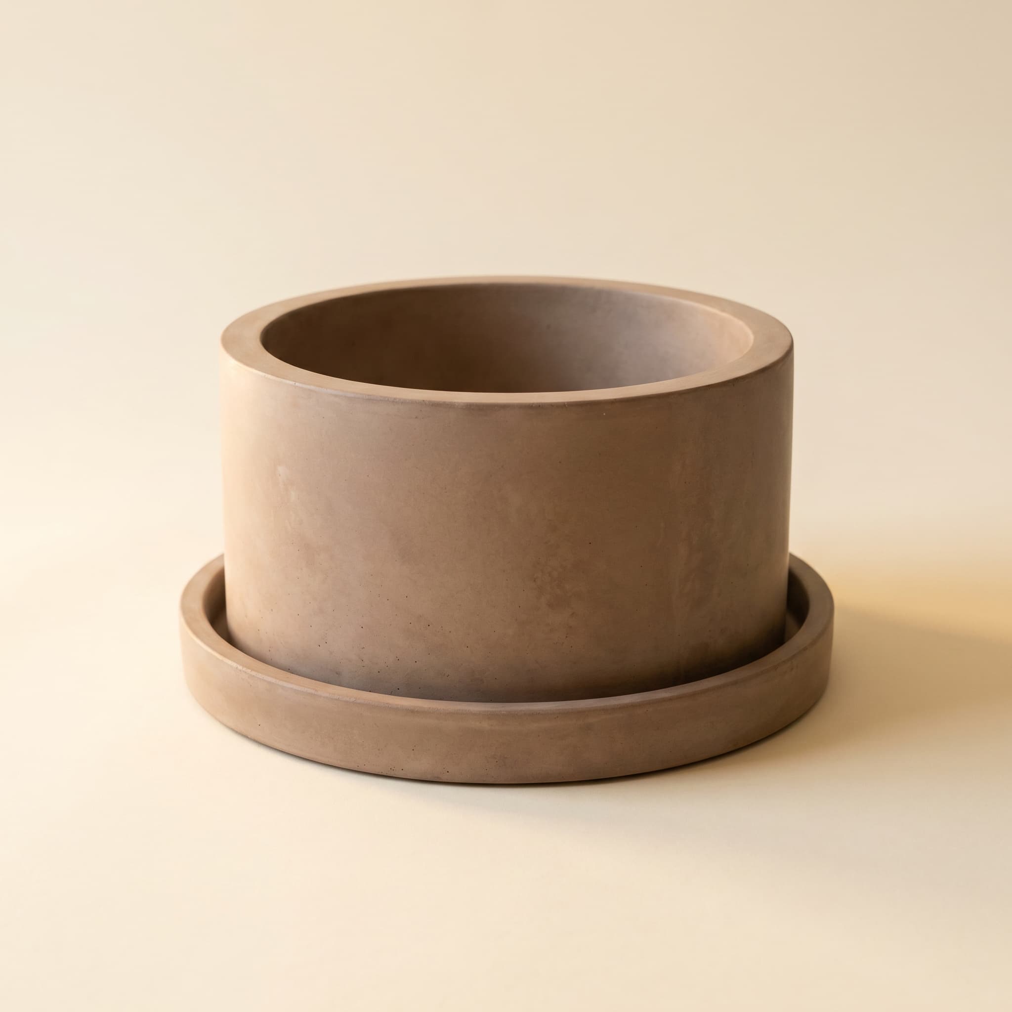 Wide taupe vessel on matching round saucer