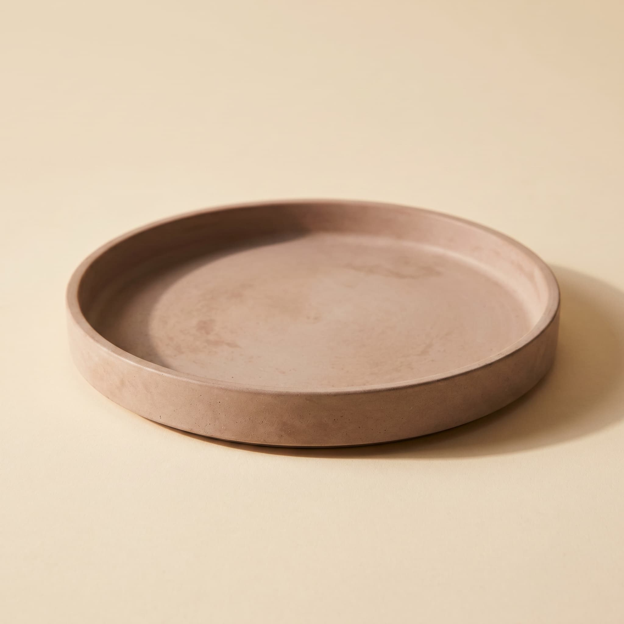 Round taupe concrete saucer